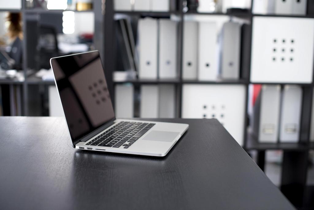 Person reading technology textbook on desk